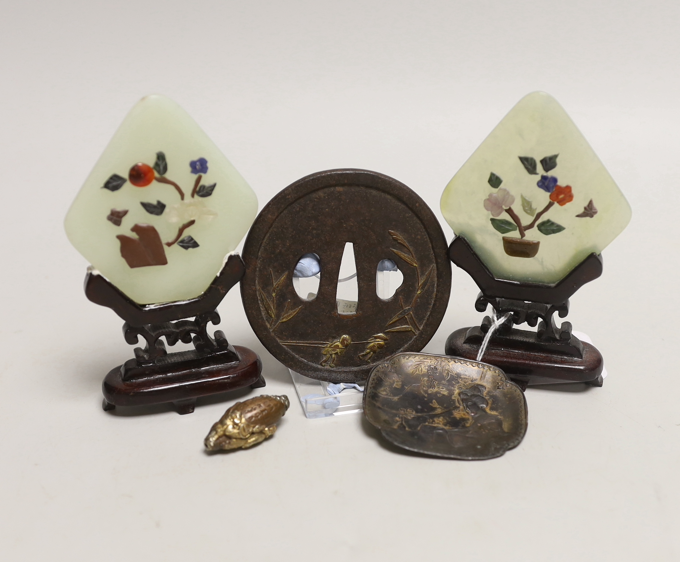 A pair of Chinese bowenite miniature table screens on hardwood stands, 12cm, a gilt cast iron Japanese tsuba, gilt bronze ojime and pin dish